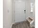 Bright foyer features wood-look floors, stairs, and a crisp white front door at 142 Rusling Leaf Dr, Fuquay Varina, NC 27526
