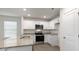 Clean kitchen features stainless appliances, granite countertops, and white cabinets at 142 Rusling Leaf Dr, Fuquay Varina, NC 27526