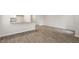 Open living area with wood-look floors, a breakfast bar, and lots of space at 142 Rusling Leaf Dr, Fuquay Varina, NC 27526