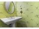 Stylish powder room featuring a unique design and pedestal sink at 144 Greenmont Ln, Cary, NC 27511