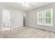 Serene bedroom with carpeted floors, neutral tones, and natural light from the double windows at 144 Greenmont Ln, Cary, NC 27511