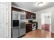 Modern kitchen featuring stainless steel appliances, wood cabinets, and granite countertops at 144 Greenmont Ln, Cary, NC 27511