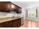 Stylish kitchen with granite countertops, stainless steel appliances, and dark wood cabinets at 144 Greenmont Ln, Cary, NC 27511