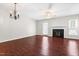 Bright living room featuring a fireplace, hardwood floors, ceiling fan and access to the outdoors at 144 Greenmont Ln, Cary, NC 27511