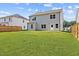 The backyard with green grass and a view of the house at 1471 Carlton Links Dr, Fuquay Varina, NC 27526