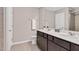 Bathroom with double vanity, stone countertop, large mirror and neutral color palette at 1471 Carlton Links Dr, Fuquay Varina, NC 27526