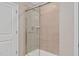 Tiled shower with glass door in updated bathroom provides a luxurious bathing experience at 1471 Carlton Links Dr, Fuquay Varina, NC 27526