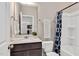 Bathroom with a vanity, tiled shower, and dark blue shower curtain at 1471 Carlton Links Dr, Fuquay Varina, NC 27526