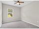 Bedroom with neutral carpet featuring a window with view to backyard and natural light at 1471 Carlton Links Dr, Fuquay Varina, NC 27526