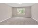 Bedroom featuring neutral carpet, a window overlooking the property, and neutral paint at 1471 Carlton Links Dr, Fuquay Varina, NC 27526