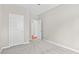 Empty bedroom features neutral carpet, natural light and a doorway to the hallway at 1471 Carlton Links Dr, Fuquay Varina, NC 27526