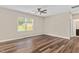 Spacious bedroom with hardwood floors, a ceiling fan, and a view of the backyard at 1471 Carlton Links Dr, Fuquay Varina, NC 27526