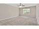 Spacious bedroom featuring neutral carpet, a ceiling fan, and large window at 1471 Carlton Links Dr, Fuquay Varina, NC 27526