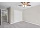A bedroom featuring gray carpet, a ceiling fan, and a closet with sliding doors at 1471 Carlton Links Dr, Fuquay Varina, NC 27526