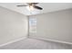 A bright bedroom featuring gray carpet, light grey walls, and a window at 1471 Carlton Links Dr, Fuquay Varina, NC 27526