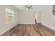 Empty bedroom with hardwood floors, ceiling fan, and a view of the front yard at 1471 Carlton Links Dr, Fuquay Varina, NC 27526