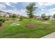 Well-maintained community area with cornhole, benches, and landscaping at 1471 Carlton Links Dr, Fuquay Varina, NC 27526