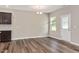 Bright dining area featuring dark wood-look floors and a window overlooking the backyard at 1471 Carlton Links Dr, Fuquay Varina, NC 27526