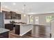 Modern kitchen featuring granite countertops, stainless steel appliances, and dark wood cabinets at 1471 Carlton Links Dr, Fuquay Varina, NC 27526