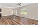 Bright living room with hardwood floors, a ceiling fan, and a view of the backyard at 1471 Carlton Links Dr, Fuquay Varina, NC 27526