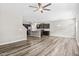 Open living room with wood floors showcasing flow to the kitchen with a view to backyard at 1471 Carlton Links Dr, Fuquay Varina, NC 27526