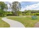 Serene community walking path with benches, surrounded by lush greenery and trees at 1471 Carlton Links Dr, Fuquay Varina, NC 27526