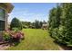 Expansive backyard featuring a lush lawn, privacy landscaping, and vibrant hydrangea bushes at 1523 Anthology Dr, Durham, NC 27703