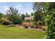 Fenced backyard with a manicured lawn and rose bushes at 1523 Anthology Dr, Durham, NC 27703