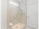 Modern shower area with glass doors, grab bars, bench and a multi-setting shower head for a spa-like experience at 1523 Anthology Dr, Durham, NC 27703