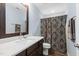Stylish bathroom featuring a modern vanity with ample counter space and a patterned shower curtain at 1523 Anthology Dr, Durham, NC 27703