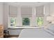 Bright bedroom with a window seat and beautiful patterned shades for a cozy and inviting space at 1523 Anthology Dr, Durham, NC 27703
