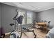 Well-lit bonus room featuring a dining table and chairs along with exercise equipment at 1523 Anthology Dr, Durham, NC 27703