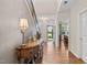 Inviting foyer featuring hardwood floors, staircase, and an antique table that creates a grand entrance at 1523 Anthology Dr, Durham, NC 27703