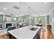 Open-concept kitchen with a large island, modern lighting, and seamless flow to living areas at 1523 Anthology Dr, Durham, NC 27703