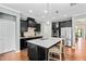 Well-equipped kitchen with stainless steel appliances, quartz countertops, and an eat-in island at 1523 Anthology Dr, Durham, NC 27703