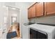 Laundry room with overhead cabinets and modern washer and dryer at 1523 Anthology Dr, Durham, NC 27703
