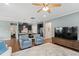Open living room featuring hardwood floors and a view into the modern kitchen at 1523 Anthology Dr, Durham, NC 27703