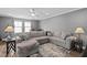 Comfortable living room with a large sectional sofa and fan for a relaxing and inviting atmosphere at 1523 Anthology Dr, Durham, NC 27703
