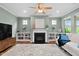 Cozy living room featuring a fireplace, built-in shelving, and hardwood flooring at 1523 Anthology Dr, Durham, NC 27703