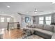 Inviting living room featuring modern decor, wood floors, and a comfortable gray sectional sofa at 1523 Anthology Dr, Durham, NC 27703