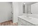Modern bathroom featuring a white vanity with ample storage, a mirror, and vinyl flooring at 153 N District Ave # 292, Clayton, NC 27527