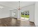 Bright dining area featuring wood floors, modern chandelier, and sliding glass doors leading to a patio at 153 N District Ave # 292, Clayton, NC 27527