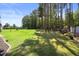 Spacious backyard with lush greenery, ideal for Gathering gatherings and outdoor fun at 175 Hawkesburg Dr, Clayton, NC 27527