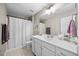 Bright bathroom features single vanity, framed mirror, and shower at 175 Hawkesburg Dr, Clayton, NC 27527