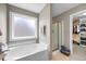 Modern bathroom features a soaking tub and glass-enclosed shower at 175 Hawkesburg Dr, Clayton, NC 27527