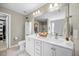 Bright bathroom features double vanity, framed mirror, and storage cabinet at 175 Hawkesburg Dr, Clayton, NC 27527