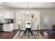 Bright breakfast nook area with lots of natural light, featuring a glass table with seating and white cabinets at 175 Hawkesburg Dr, Clayton, NC 27527