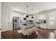 Bright kitchen featuring stainless appliances, white cabinetry, dark hardwood floors, and a breakfast bar with seating at 175 Hawkesburg Dr, Clayton, NC 27527