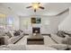 Inviting living room with a fireplace, comfortable seating, hardwood floors, and a ceiling fan for climate control at 175 Hawkesburg Dr, Clayton, NC 27527