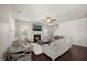 Cozy living room featuring a fireplace, hardwood floors, comfortable seating, and natural light from multiple windows at 175 Hawkesburg Dr, Clayton, NC 27527